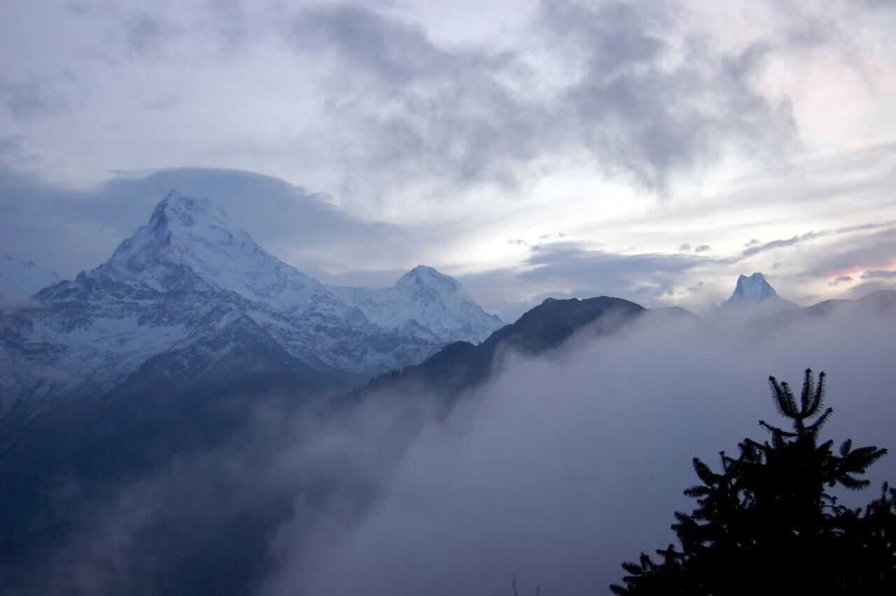 mountains covered with clouds and snow