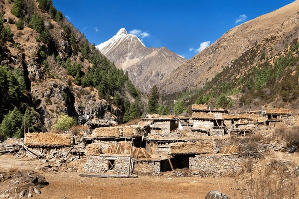 Traditional stone houses in Pungmo village surrounded by Himalayan peaks along the Upper Dolpo Trek route in western Nepal.